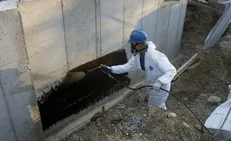 Professional waterproofing the exterior walls of the basement in Chandler, AZ