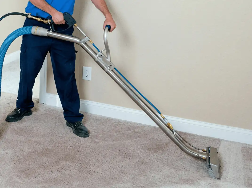 Professional operating a liquid removal machine on a carpeted floor in Chandler, AZ